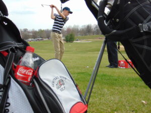 Central High School golfer Josh Glore receives instruction from Jim Gregory of Millwood Golf and Racquet Club during the Missouri Sports Hall of Fame's High School Hole in One Clinic presented by Ozarks Coca-Cola/Dr Pepper on Monday at Highland Springs Country Club.