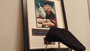 A Payne Stewart Ivy hat sits in front of a framed photo at the Hall.