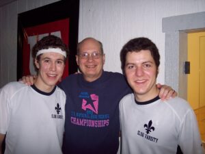 Joe Koestner with two of his racquetball players who have helped SLUH win nine national titles.