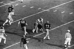 Photo courtesy of MU Athletic Department Digital ArchivesMU Hist FB Bk 1909-200819660101 MU v Florida Halfback Johnny Roland (23) gets ready to launch an 11-yard scoring pass to Earl Denny (45) against Florida in Sugar Bowl game.