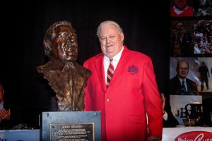 Longtime Central Missouri athletic director Jerry Hughes next to the bronze bust that will line the Legends Walkway.