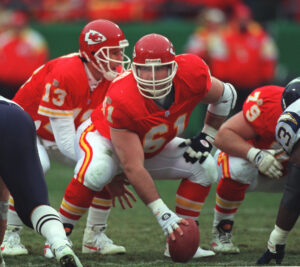 Kansas City Chiefs center Tim Grunhard (61) snaps the ball to Kansas City Chiefs quarterback Steve Bono (13) during the Nov. 24 1996 home game against the San Diego Chargers. The Chiefs lost 14-28.