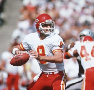 Kansas City Chiefs quarterback Bill Kenney (9) gets ready to throw the ball during a 1985 NFL game against the Los Angeles Raiders.