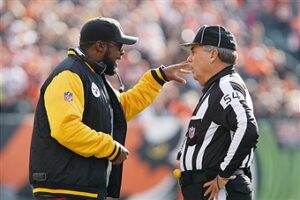 December 07 2014: Pittsburgh Steelers head coach Mike Tomlin talks to head linsman George Hayward during the first quarter of the game against the Cincinnati Bengals at Paul Brown Stadium in Cincinnati, Ohio.