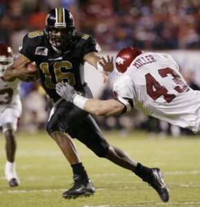 Missouri's Brad Smith stiff-arms Arkansas' Caleb Miller during the second half of Arkansas' 27-14 win over Missouri in the Independence Bowl at Independence Stadium in Shreveport, La., on Wednesday, Dec. 31, 2003. 2003 Independence Bowl - Missouri vs. Arkansas Independence Stadium Shreveport, Louisiana United States December 31, 2003 Photo by David Yerby/WireImage.com To license this image (1985637), contact WireImage: +1 212-686-8900 (tel) +1 212-686-8901 (fax) st@wireimage.com (e-mail) www.wireimage.com (web site)