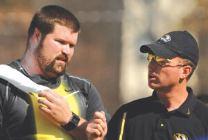 Christian Cantwell talks with coach Brett Halter during the shot put in the 80th Kansas Relays at Memorial Stadium in Lawrence, Kan. on Friday, April 20, 2007. Cantwell won with a throw of 68-6 (20.66m).