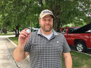 Adam Harris shows off the ball he landed for a hole in one Monday morning.
